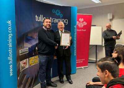 Lewis Clayton accepts his certificate from Iain Garrett, CEO at Tullos Training Ltd