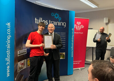 Crighton Byres accepts his certificate from Iain Garrett, CEO at Tullos Training Ltd