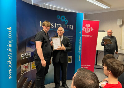Ryan Stirling accepts his certificate from Iain Garrett, CEO at Tullos Training Ltd