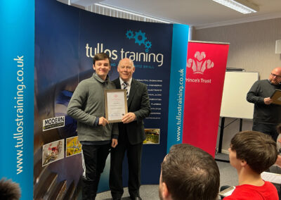 Connor Organ accepts his certificate from Iain Garrett, CEO at Tullos Training Ltd