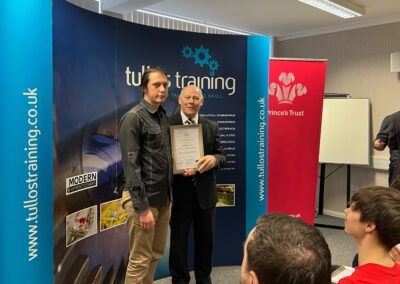 Maksym Vatsyk accepts his certificate from Iain Garrett, CEO at Tullos Training Ltd