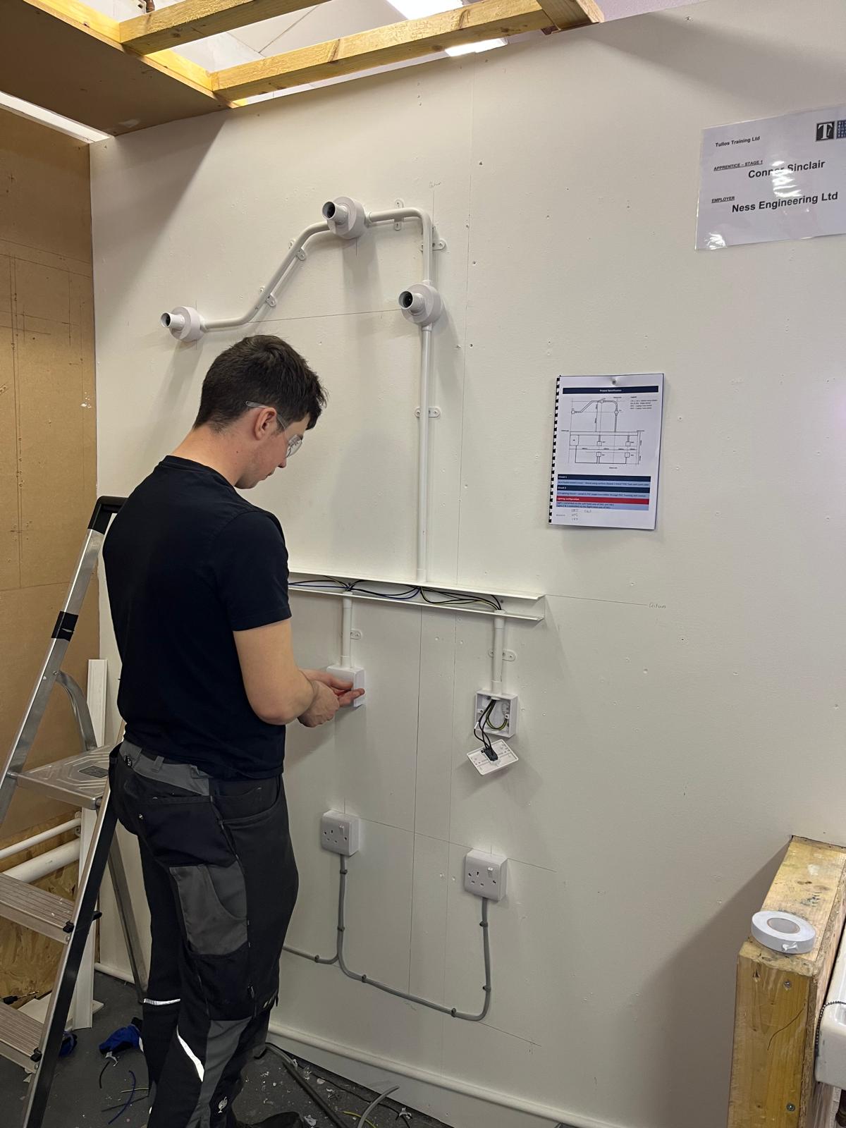 Connor Sinclair of Ness Engineering is pictured working on his electrical installation as part of the competition.